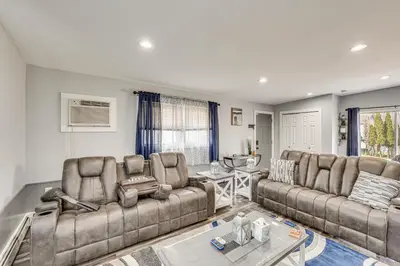 a living room with two couches and a table at Waterfront Wallkill Duplex Home with Fire Pits! in Wallkill