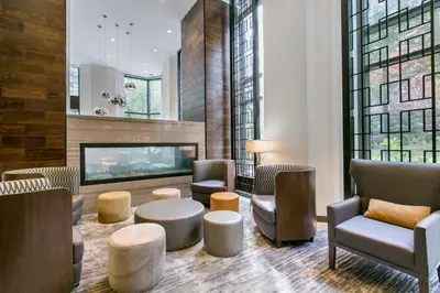 a lobby with chairs tables and a fireplace at Tribeca Studio w Tons of light Gym Pool NYC-118 in New York