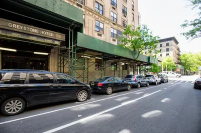 a row of cars parked on the side of a street at UWS 1br w gym doorman nr Central Park NYC-1100 in New York