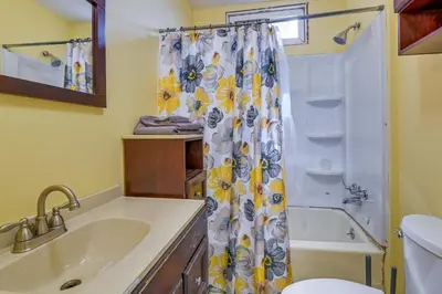 a bathroom with a sink and a shower with a shower curtain at Upstate New York Vacation Rental Near Cooperstown! in Cherry Valley