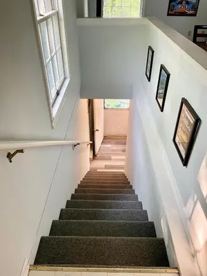 a staircase in a house with white walls at Walk to the Outfield of Lime Rock Park in Salisbury