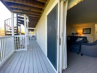 a porch with a glass door and a couch at The Central Downtown Inn Suites in Pittsfield