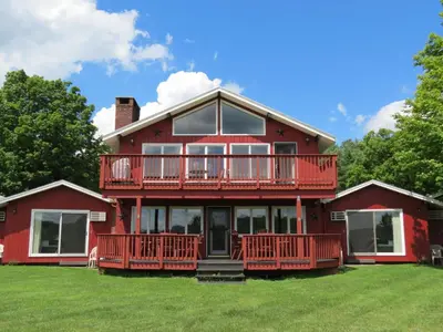 a large red house with a large deck at North Shire Lodge in Manchester