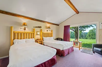 two beds in a room with a window at North Shire Lodge in Manchester