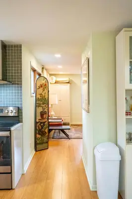 an open kitchen with a refrigerator and a table at Quiet place with easy access NYC in River Edge