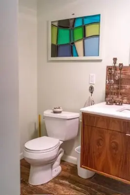 a bathroom with a toilet and a sink and a mirror at Quiet place with easy access NYC in River Edge