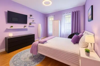 a purple bedroom with a bed and a tv at Lavender style Room in Geusthouse in New York