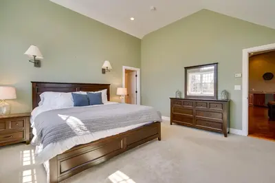 a bedroom with a bed and two dressers and a mirror at Serene Retreat Near Mt Snow Great for Groups! in Marlboro