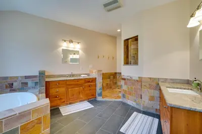 a large bathroom with two sinks and a tub at Serene Retreat Near Mt Snow Great for Groups! in Marlboro