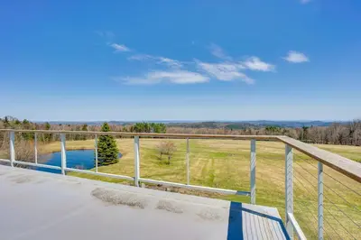 a view from the balcony of a house with a pond at Wellness Retreat with Views! Upscale Marlboro Cabin in Marlboro
