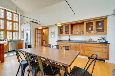 a large kitchen with a wooden table and chairs at Wellness Retreat with Views! Upscale Marlboro Cabin in Marlboro