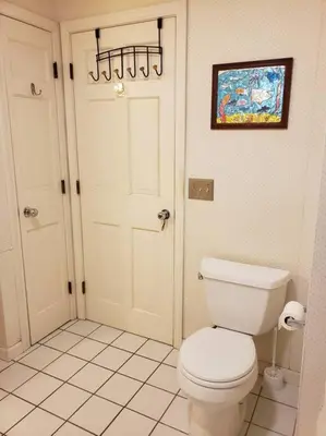 a bathroom with a white toilet and a door at Charming mountain view country house in Cheshire