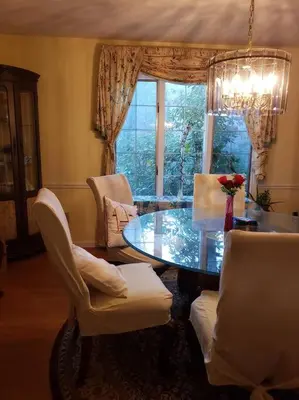 a dining room with a table and chairs and a window at Charming mountain view country house in Cheshire