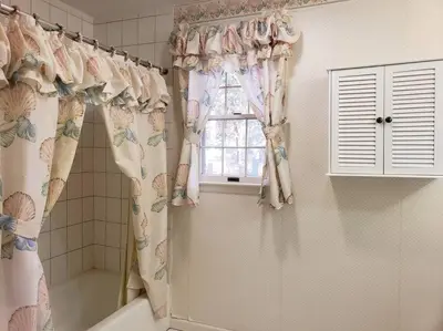 a bathroom with a shower curtain and a window at Charming mountain view country house in Cheshire