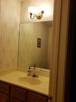 a bathroom with a sink and a large mirror at Charming mountain view country house in Cheshire