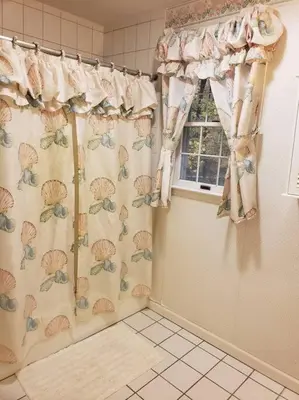 a bathroom with a shower curtain and a window at Charming mountain view country house in Cheshire