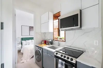 a kitchen with a sink and a stove top oven at 48-5FE Brand New 2BR in prime Midtown in New York