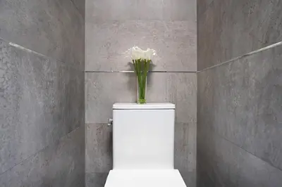 a white flower on top of a toilet in a bathroom at 48-5RW 1BR Apartment in Midtown West W D in New York