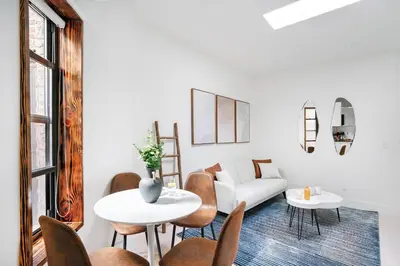 a living room with a couch and a table and chairs at 48-5RW 1BR Apartment in Midtown West W D in New York