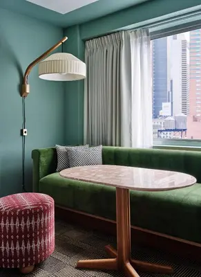 a living room with a green couch and a table at Romer Hell's Kitchen in New York