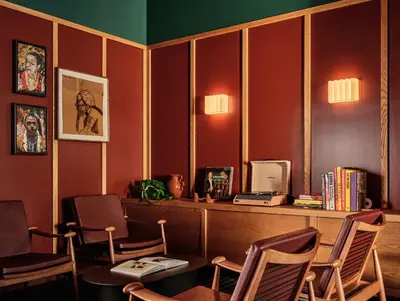 a waiting room with chairs and a table and a computer at Romer Hell's Kitchen in New York