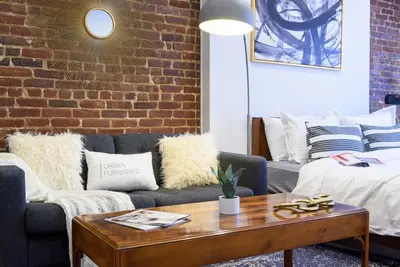 a living room with a couch and a coffee table at 83-3W UES Central Park Newly Furnished XL Studio in New York