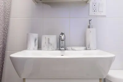 a bathroom sink with a faucet on top of it at 83-3W UES Central Park Newly Furnished XL Studio in New York