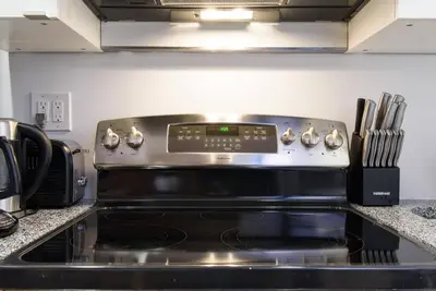 a stove top oven sitting in a kitchen at 83-3W UES Central Park Newly Furnished XL Studio in New York
