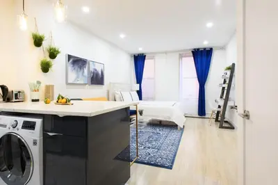 a kitchen and living room with a washer and dryer at 1597-9 Renovated Studio Prime UES WD in unit in New York