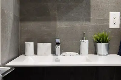 a white sink in a bathroom with plants on it at 1597-9 Renovated Studio Prime UES WD in unit in New York