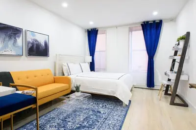 a bedroom with a bed and a couch at 1597-9 Renovated Studio Prime UES WD in unit in New York
