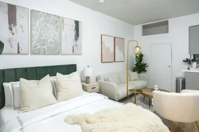 a bedroom with a white bed and a chair at 74-1A New Studio in Prime UWS - GYM In Building in New York
