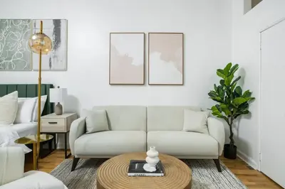 a living room with a couch and a table at 74-1A New Studio in Prime UWS - GYM In Building in New York