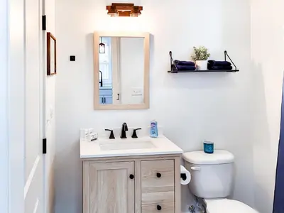 a bathroom with a sink and a mirror and a toilet at Stylish studio in Bristol, newly renovated! in Bristol