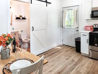 a kitchen with a dining table and a white door at Stylish studio in Bristol, newly renovated! in Bristol