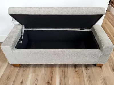 a large gray couch sitting on top of a wooden floor at Stylish studio in Bristol, newly renovated! in Bristol