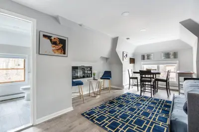 a living room with a couch and a table at Cozy Studio with 1 Bed & Comfy Sofa Bed in New Rochelle