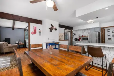 a dining room and kitchen with a wooden table at Breathtaking views. Hot tub. Huge Deck. Fast Wifi in Andes
