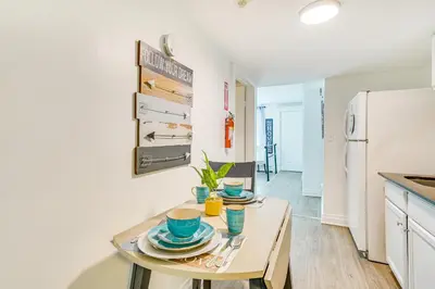 a kitchen with a table with plates and cups on it at Walk to Downtown Albany Ten Broeck Triangle Apt! in Albany