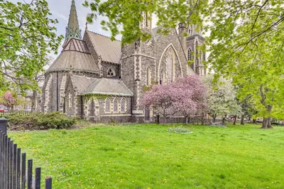 an old church with a fence in front of it at Walk to Downtown Albany Ten Broeck Triangle Apt! in Albany