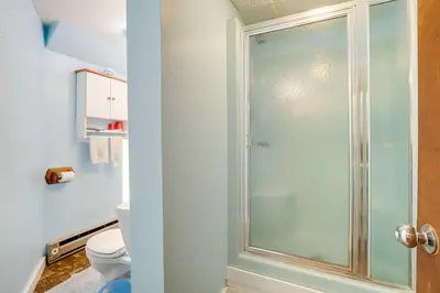 a bathroom with a glass shower with a toilet at Spacious Woodbury Home with Pool and Hot Tub! in Woodbury