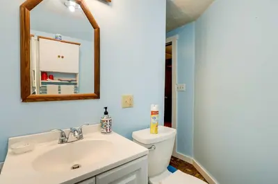a bathroom with a sink and a toilet at Spacious Woodbury Home with Pool and Hot Tub! in Woodbury