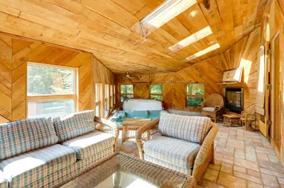 a living room with two couches and a fireplace at Spacious Woodbury Home with Pool and Hot Tub! in Woodbury