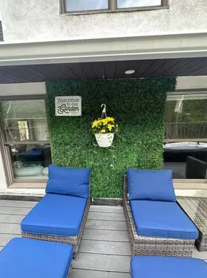 two blue cushioned chairs in front of a store at Sleek 1 Bedroom Apartment Plus Balcony 30 Mins to NYC in New Rochelle