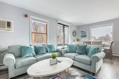 a living room with two couches and a table at Sleek 1 Bedroom Apartment Plus Balcony 30 Mins to NYC in New Rochelle