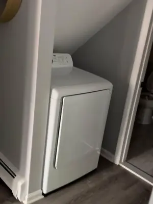 a white washer and dryer in a small room at Sleek 1 Bedroom Apartment Plus Balcony 30 Mins to NYC in New Rochelle