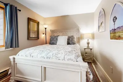 a bedroom with a white bed in a room at Mountain View Chalet in West Dover