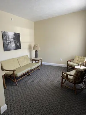 a living room with two couches and a table at Lake Front Hotel in Cooperstown