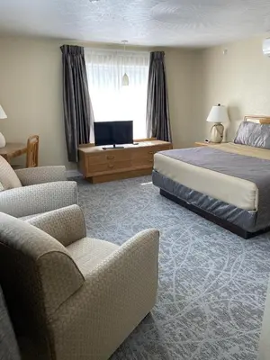 a hotel room with two beds and a television at Lake Front Hotel in Cooperstown
