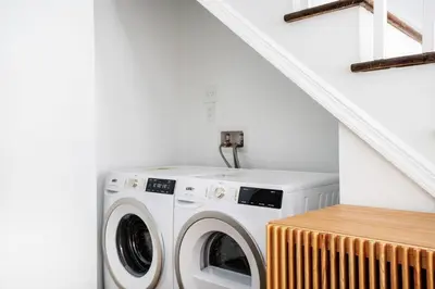 a washer and dryer in a white laundry room at 91-1D 3BR 2baths Duplex with a Private Back yard - GYM in New York